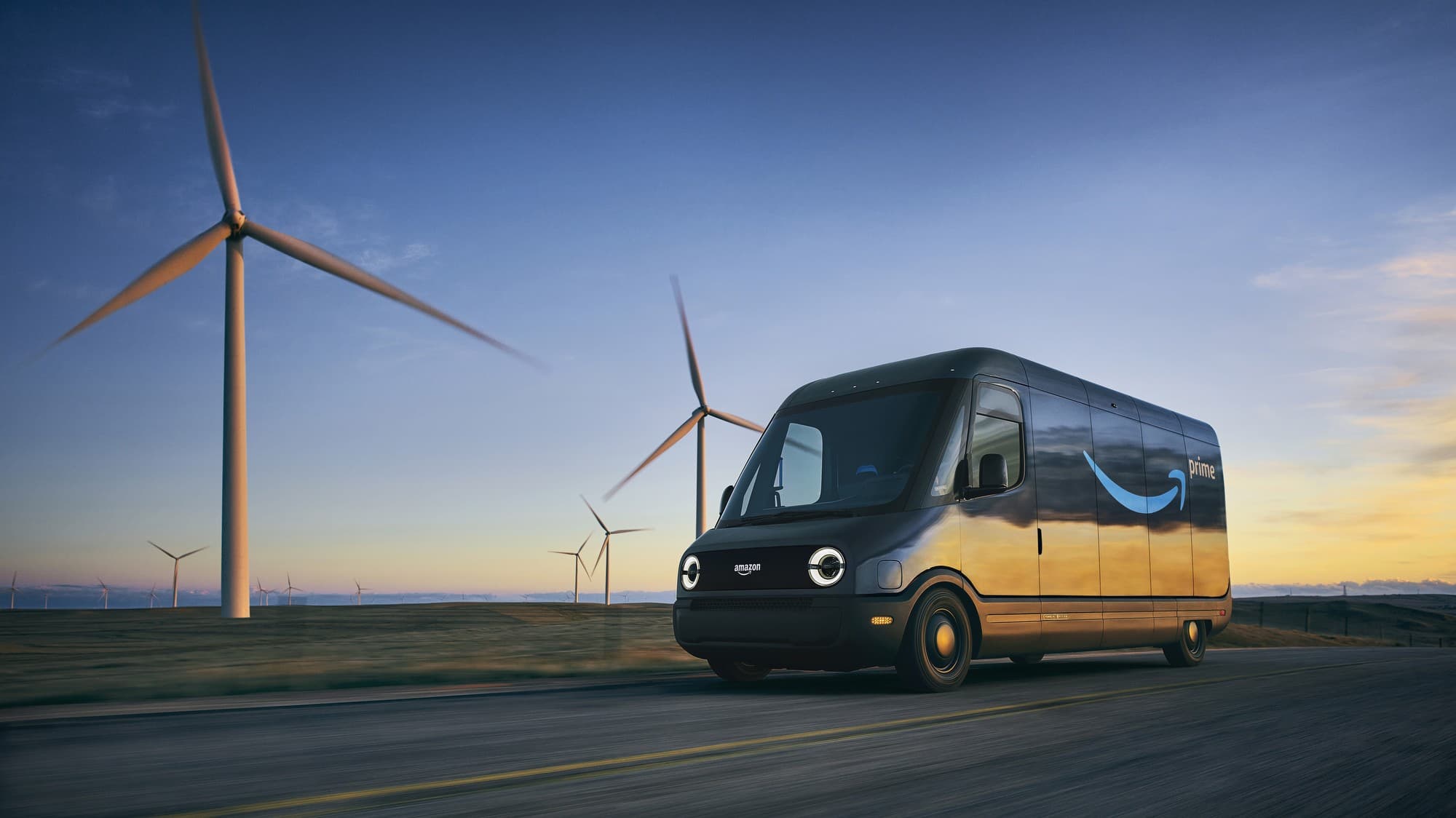 An electric Amazon delivery van on the road past wind turbines at sunset